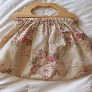 Gorgeous tan and floral fabric bag with wood handles.